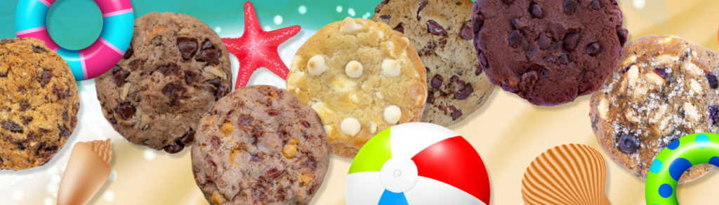 Cookies, sea shells, and floating devices over sand and water at a beach.
